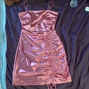 I am selling a mini dress. That is rose gold and it was only worn once.